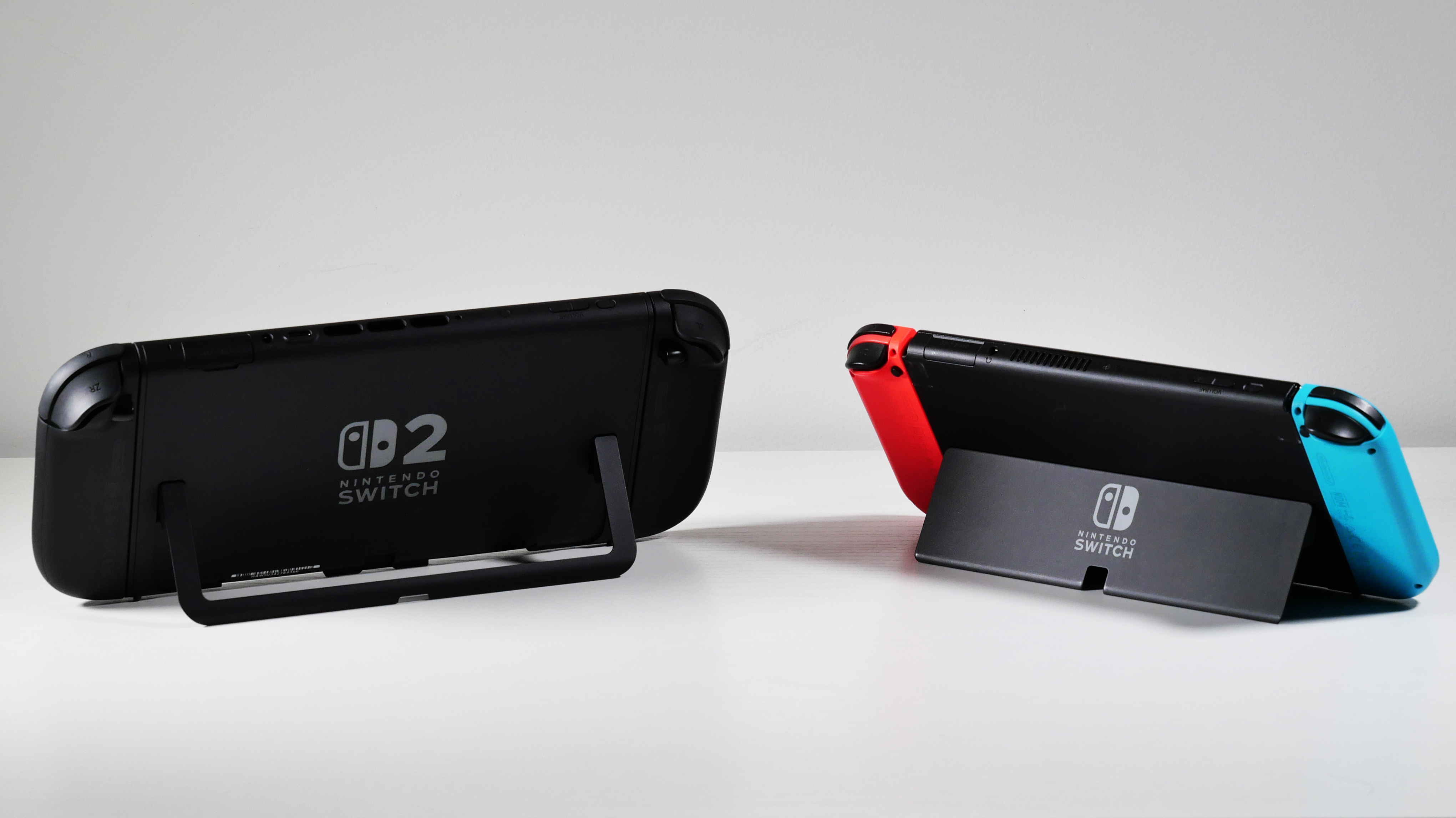 Το Nintendo Switch 2 και ο διακόπτης OLED δίπλα -δίπλα, επισημαίνοντας τα kickstands τους.